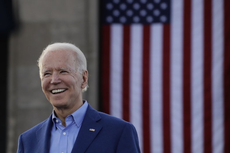 FILE - In this March 7, 2020, file photo Democratic presidential candidate former Vice President Joe Biden acknowledges the crowd during a campaign rally in Kansas City, Mo. In an effort to ease concerns about his age, the 77-year-old presumptive Democratic nominee has said he wouldn't seek reelection if his mental or physical health declined. He has also referred to himself as a “transition candidate," acting as a bridge to a younger generation of leadership. (AP Photo/Charlie Riedel, File)