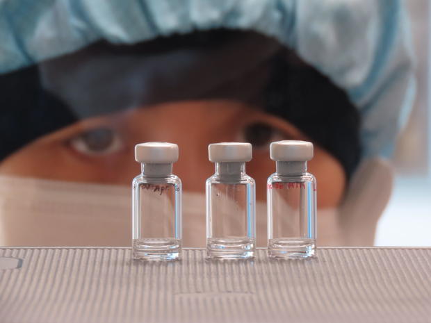 A photo provided by the COVID-19 Vaccine Team at the University of Oxford's Vaccine Centre in England shows a researcher working on the manufacture of a potential vaccine for the disease caused by the new coronavirus. SEAN ELIAS/OXFORD VACCINE CENTRE