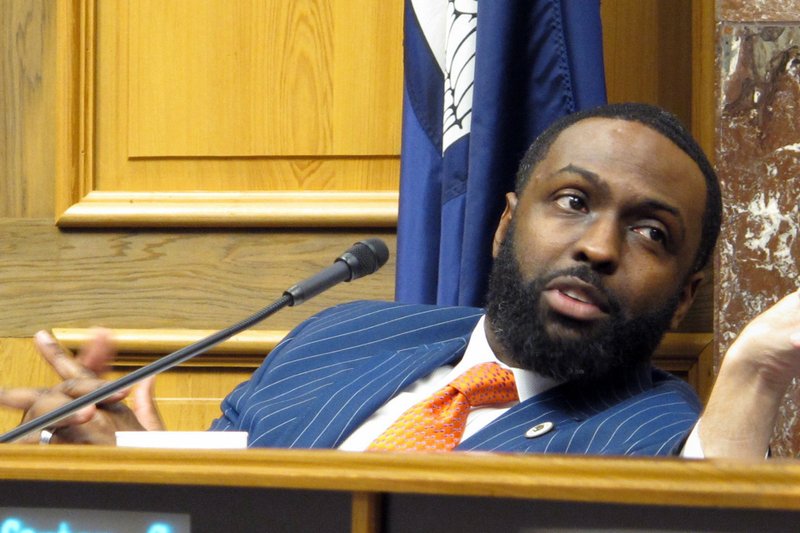 FILE - In this Feb. 7, 2018, file photo, state Rep. Ted James, D-Baton Rouge speaks with a colleague during a legislative hearing in Baton Rouge, La. Gov. John Bel Edwards has thrown his support to James to be the next leader of the Louisiana Democratic Party. The governor's endorsement Friday, Aug. 14, 2020 gives the lawmaker an edge in the competition. (AP Photo/Melinda Deslatte, File)