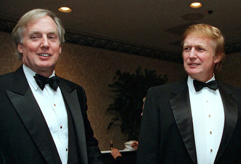 FILE - In this Nov. 3, 1999 file photo, Robert Trump, left, joins then real estate developer and presidential hopeful Donald Trump at an event in New York. President Donald Trump's younger brother, Robert Trump, has been hospitalized in New York, according to the White House. The president is expected to visit his 72-year-old brother at a hospital in Manhattan on Friday. (AP Photo/Diane Bonadreff, File)