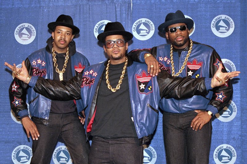 FILE - The rap group Run-DMC, from left, Joseph "Run" Simmons, Darryl "DMC" McDaniels, and Jason Mizell "Jam Master Jay," poses at the 31st annual Grammy Awards in New York, on March 2, 1988. Two suspects have been indicted in the 2002 killing of hip hop artist Jam Master Jay, which until now had been one of New York City's most notorious unsolved killings, according to two law enforcement officials, Monday, Oct. 17, 2020. (AP Photo/Mark Lennihan, File)