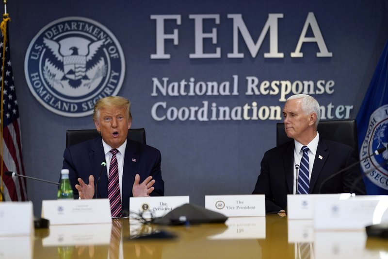 President Donald Trump speaks during a Hurricane Laura briefing at FEMA headquarters, Thursday, Aug. 27, 2020, in Washington. Vice President Mike Pence listens at right. (AP Photo/Evan Vucci)