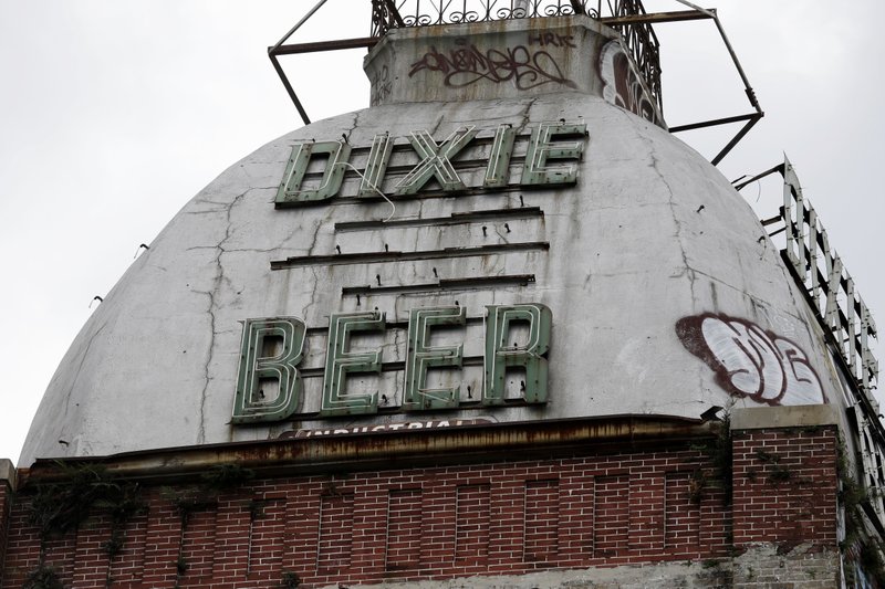 FILE - This July 3, 2013, file photo, shows the top of the abandoned Dixie Beer brewery on Tulane Avenue in New Orleans. The iconic Louisiana brewery, Dixie Beer, which has been around since 1907, will now be known as Faubourg Brewing Company after the nationwide uproar over racial discrimination sparked the company earlier this summer to ditch the name associated with the Confederacy. Gayle Benson, the owner of the NFL Saints who also owns a majority share in the brewery, announced the new name in a news release Wednesday, Nov. 4, 2020. (AP Photo/Gerald Herbert, File)