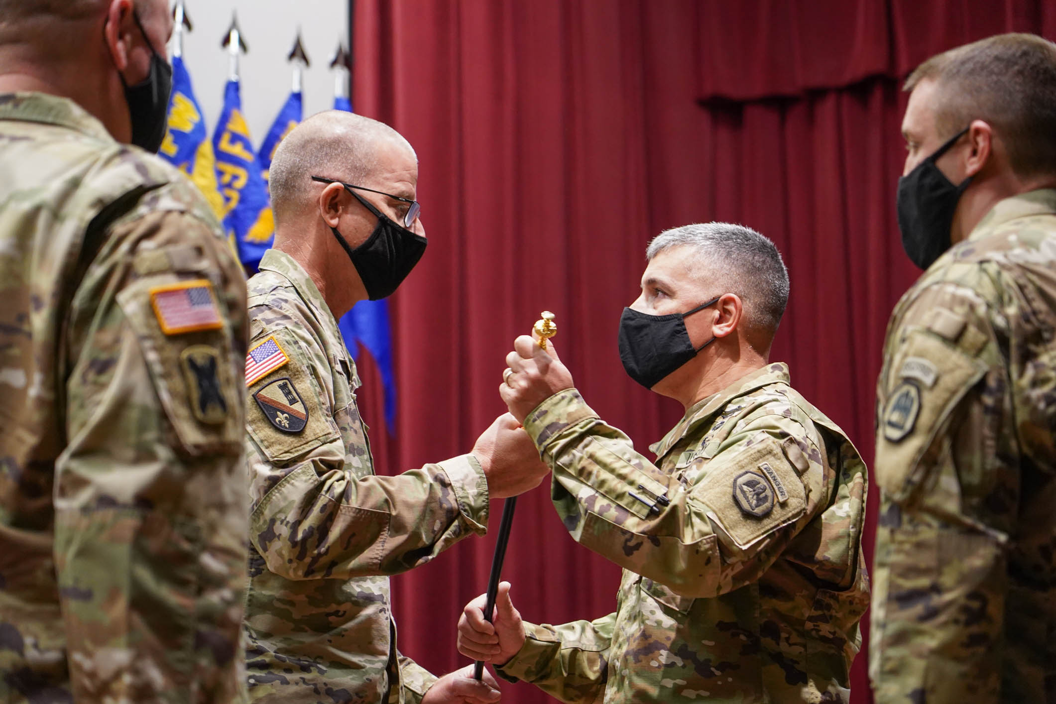 Command Sgt. Major Clifford Ockman Jr. receives the Noncommissioned Officer Sword from Brig. Gen. D. Keith Waddell, adjutant general of the Louisiana National Guard, signifying the assumption of responsibility as the senior enlisted leader of the entire LANG at the Camp Beauregard post theater in Pineville, La., Dec. 6, 2020. (U.S. Army National Guard photo by Sgt. 1st Class Denis B. Ricou)