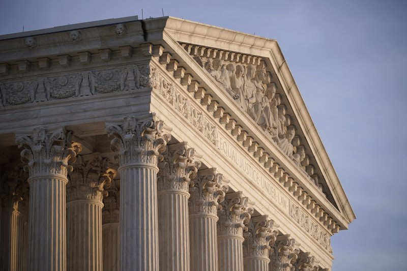 FILE - In this Nov. 5, 2020, file photo the Supreme Court is seen in Washington. The Supreme Court on Wednesday, Dec. 2, struggled with whether to require new trials for potentially thousands of prisoners in Louisiana and Oregon who were convicted by non-unanimous juries before the court barred the practice last year. (AP Photo/J. Scott Applewhite, File)