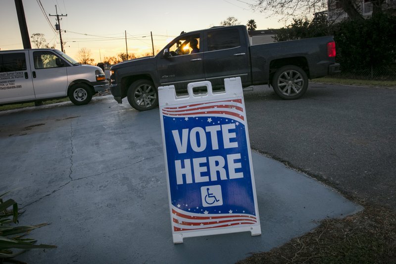The sunsets as people arrive to vote at St. Paul Missionary Baptist Church in Ironton, Louisiana for Election Day on Tuesday, Nov. 3, 2020. (Chris Granger/The Advocate via AP)