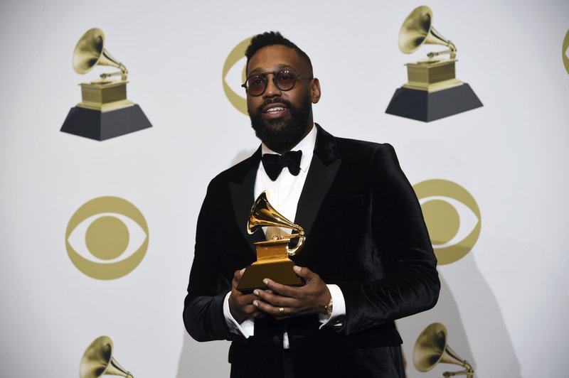 FILE - In this Sunday, Jan. 26, 2020 file photo, PJ Morton poses in the press room with the award for best R&B song for "Say So" at the 62nd annual Grammy Awards at the Staples Center in Los Angeles. A New Orleans high school is celebrating Grammy nominations for four of its graduates. St. Augustine High School alumni PJ Morton, Timothy Thedford, Jonathan Batiste and Luke James are each up for best album in different categories at the awards show Sunday, March 14, 2021.(AP Photo/Chris Pizzello, File)