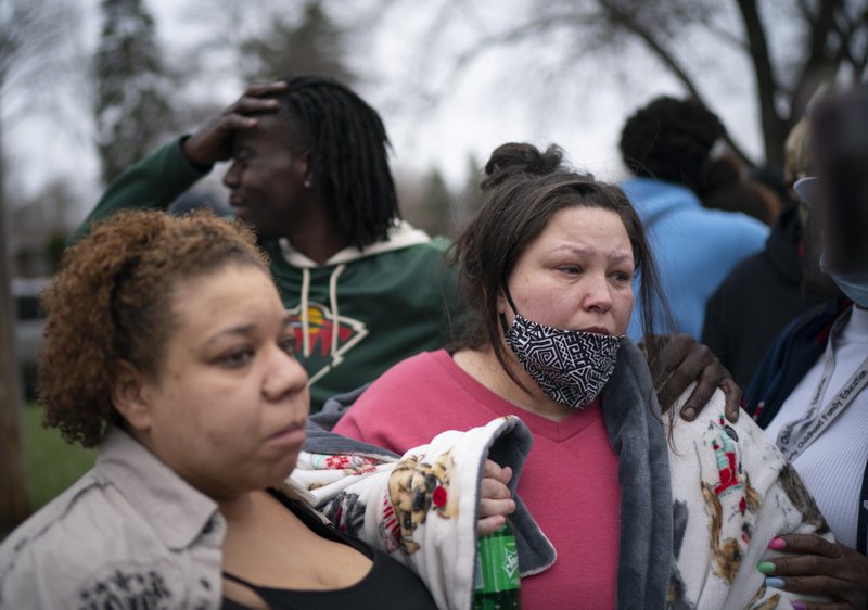 Friends and family comfort Katie Wright, right, while she speaks briefly to news media near where the family says her son Daunte Wright, 20, was shot and killed by police Sunday, April 11, 2021, in Brooklyn Center, Minn. (Jeff Wheeler/Star Tribune via AP)