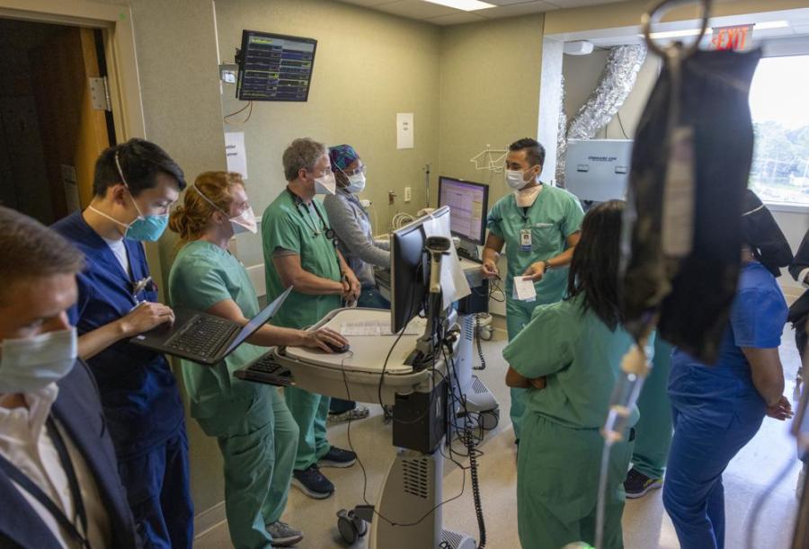 FILE - In this Tuesday, Aug. 10, 2021 file photo, Medical staff from multiple departments gather on the COVID ICU floor at Ochsner Medical Center in Jefferson, La. Louisiana hospitals already packed with patients from the latest coronavirus surge are now bracing for a powerful Category 4 hurricane, which is expected to crash ashore Sunday, Aug. 29, 2021. (Chris Granger/The Times-Picayune/The New Orleans Advocate via AP, File)
