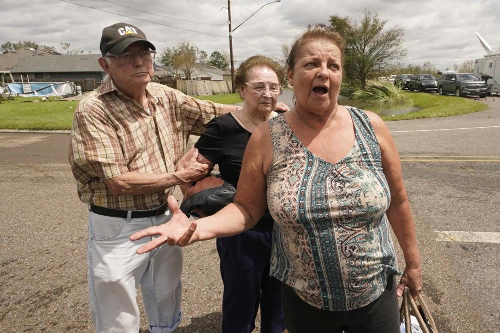Residents of the Spring Meadow subdivision, Debbie Greco, and her parents Fred Carmouche, and his wife Faye, talk to the media after being helped out of their flood ed home on a boat after Hurricane Ida moved through Monday, Aug. 30, 2021, in LaPlace, La. (AP Photo/Steve Helber)