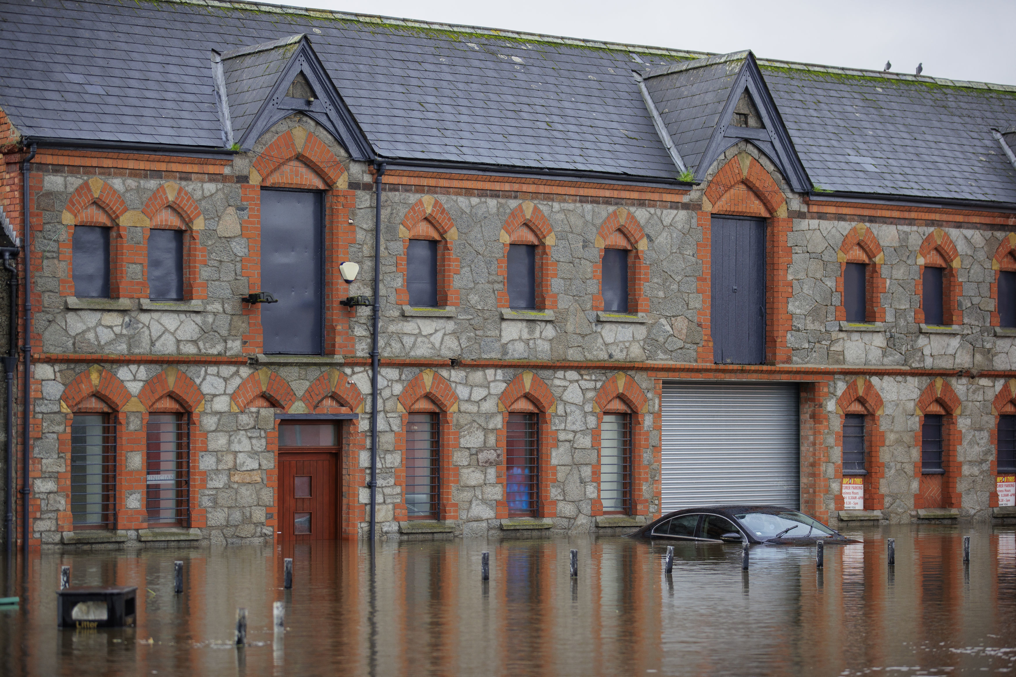 A car submerged in flood water at Basin Walk Car Park in Newry Town, Co Down, Tuesday Oct. 31, 2023. Flooding was reported in parts of Northern Ireland, with police cautioning people against travelling due to an amber rain warning. (Liam McBurney/PA via AP)